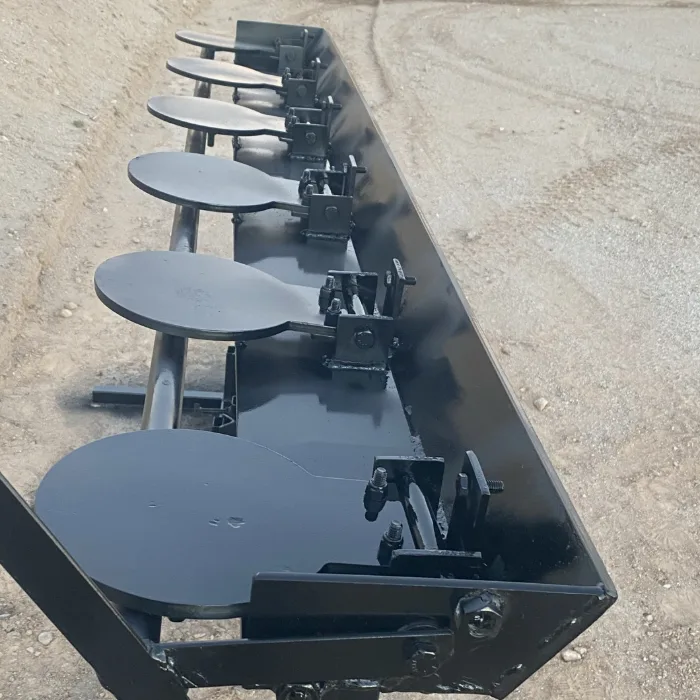 Close-up of the built rack from above: the six round steel paddles lying flat along the bar, each on its own bolted bracket